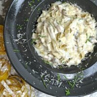 Delicious fettuccine alfredo topped with fresh herbs and grated parmesan cheese.
